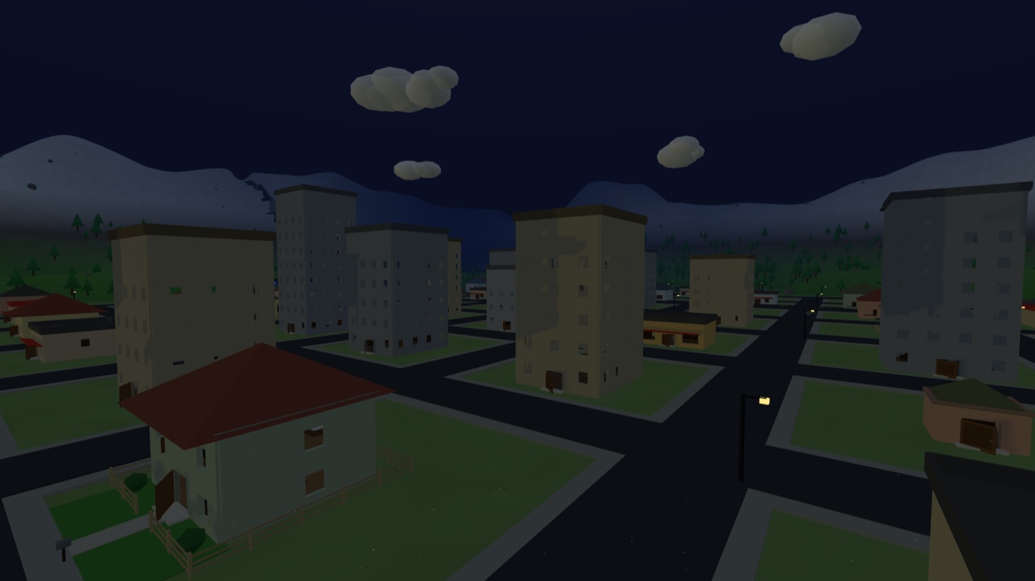 A cidade à noite, com janelas acesas, postes ligados e as montanhas em azul escuro ao fundo.